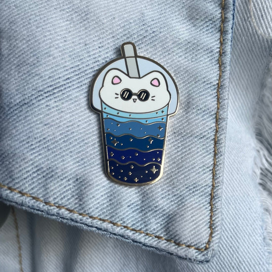cat boba enamel pin on the collar of a denim jacket