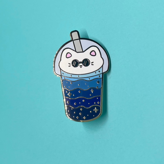 cat boba enamel pin on blue background